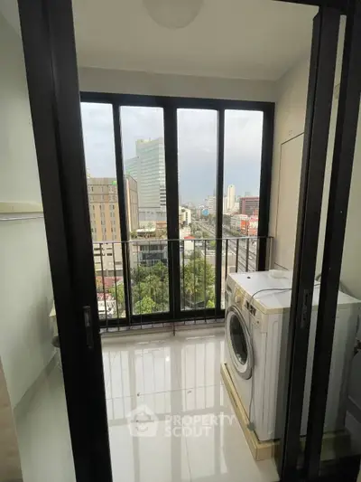 Modern apartment balcony with city view and washing machine