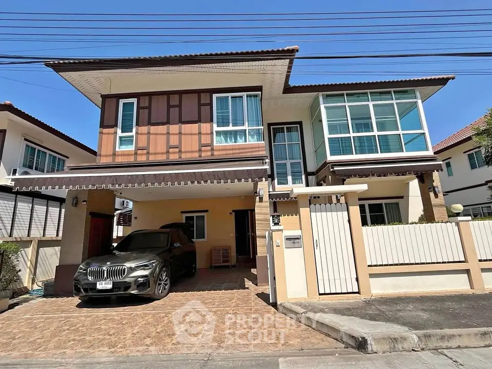 Modern two-story house with carport and stylish facade in suburban neighborhood.