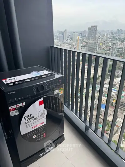 High-rise balcony with city view and new Toshiba washing machine.