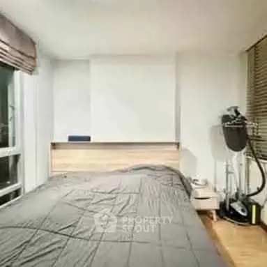 Cozy bedroom with modern decor and large window for natural light