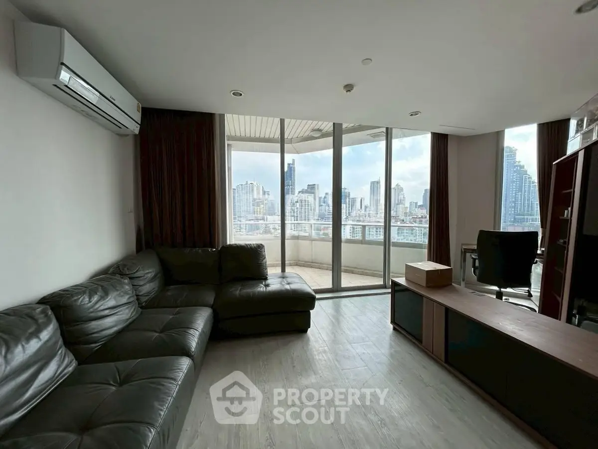 Spacious living room with city view and large balcony access