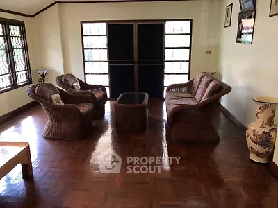 Charming living room with wicker furniture and polished wood flooring