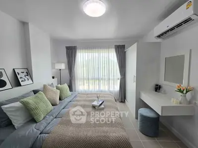 Modern bedroom with stylish decor, featuring a cozy bed, elegant curtains, and a wall-mounted air conditioner.