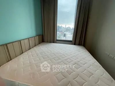 Spacious bedroom with large window offering stunning city view in modern apartment