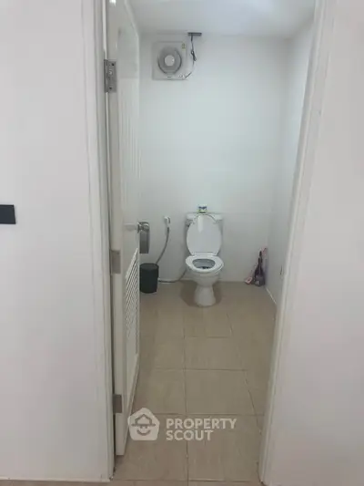 Minimalist bathroom with white walls and basic fixtures