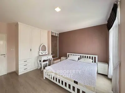 Spacious bedroom with elegant white furniture and natural light