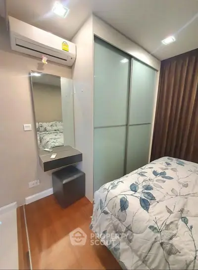 Cozy bedroom with modern decor and built-in wardrobe in a stylish apartment.
