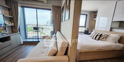 Modern apartment with spacious living room and bedroom, featuring a balcony with city views.