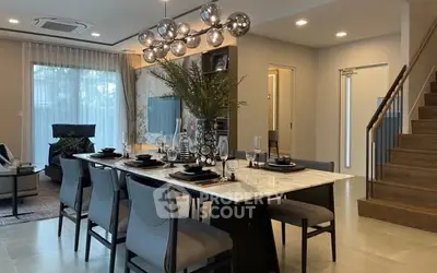 Elegant dining room with modern chandelier and stylish decor in a luxurious home setting.