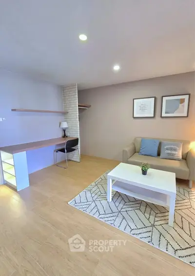 Modern living room with cozy sofa, stylish decor, and spacious desk area.