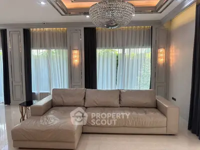 Luxurious living room with elegant chandelier and plush leather sofa