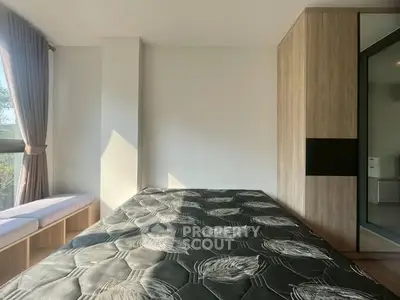 Modern bedroom with large window and built-in wardrobe