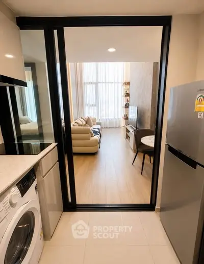 Modern apartment with open kitchen and cozy living room featuring floor-to-ceiling windows.