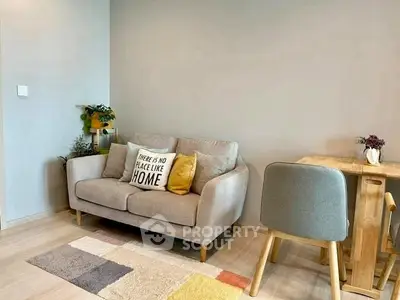 Cozy living room with modern sofa and dining area, perfect for relaxation.