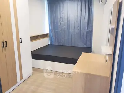 Modern minimalist bedroom with sleek furniture and ample storage space.