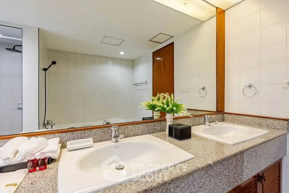 Spacious bathroom with dual sinks and elegant decor