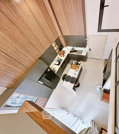 Modern kitchen with sleek design and open layout, featuring high-end appliances and stylish wood finishes.