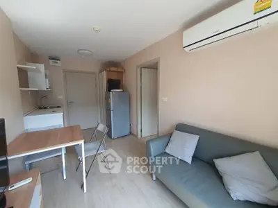 Cozy living room with modern furniture and compact kitchen area