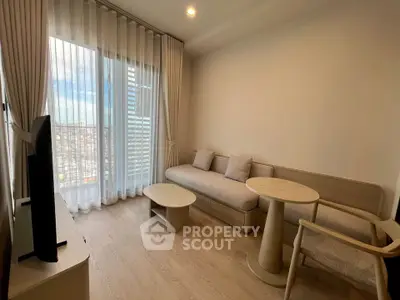 Modern living room with floor-to-ceiling windows and minimalist furniture in a high-rise apartment.