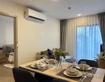 Modern dining area with elegant table setting and cozy living space