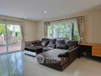 Spacious living room with large windows and modern sectional sofa