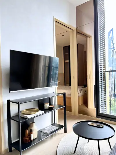 Modern living room with sleek TV stand and balcony view in high-rise apartment