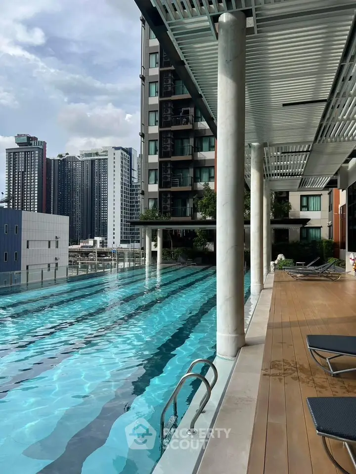 Luxurious high-rise building with stunning rooftop pool and city views.