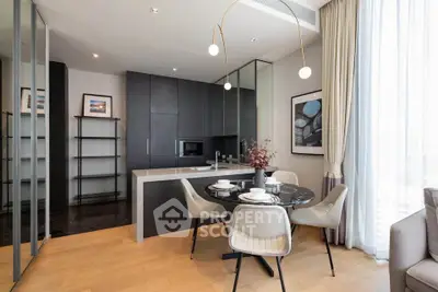 Modern kitchen with sleek black cabinets and elegant dining area in a stylish apartment.
