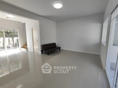 Spacious modern living room with sleek tile flooring and natural light