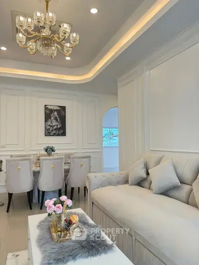 Elegant living room with luxurious chandelier and stylish dining area