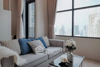 Luxurious living room with stunning city view, elegant decor, and plush seating in a high-rise apartment.