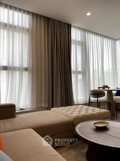 Luxurious living room with elegant curtains and modern furniture in a high-rise apartment.