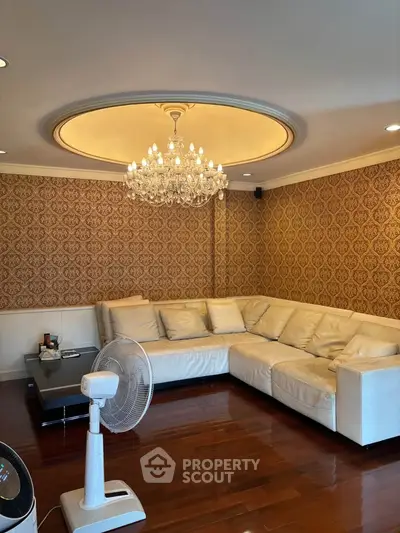 Elegant living room with chandelier and luxurious sofa