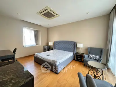 Spacious bedroom with elegant furniture and natural light