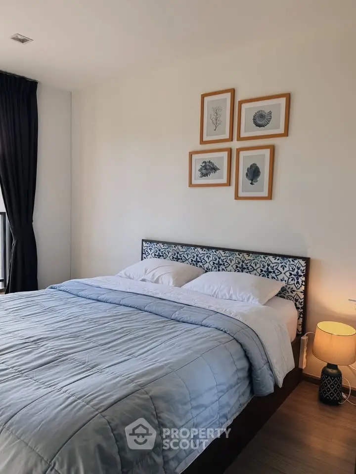 Cozy bedroom with stylish decor and natural light, perfect for relaxation.