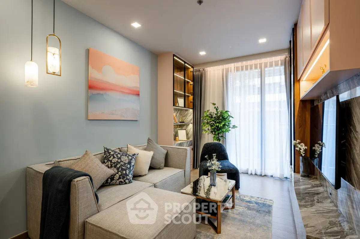 Modern living room with stylish decor, cozy seating, and elegant lighting.