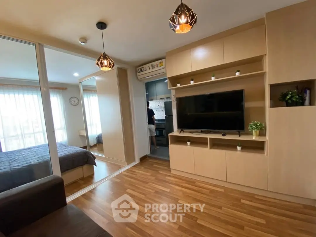 Modern living room with wooden flooring and built-in TV cabinet