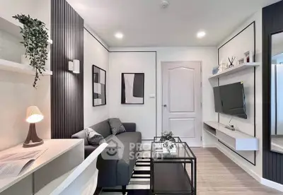 Modern living room with sleek design, featuring a cozy sofa, wall-mounted TV, and stylish decor.