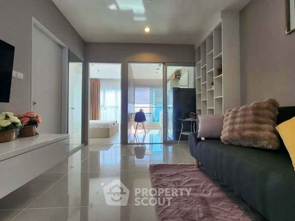 Modern living room with sleek design and open layout, featuring cozy seating and stylish decor.