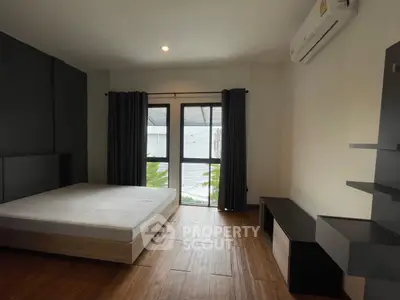 Spacious bedroom with modern design and large window for natural light