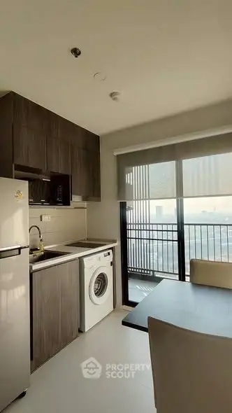 Modern kitchen with washing machine and balcony view