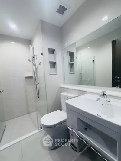Modern bathroom with sleek fixtures and glass shower enclosure