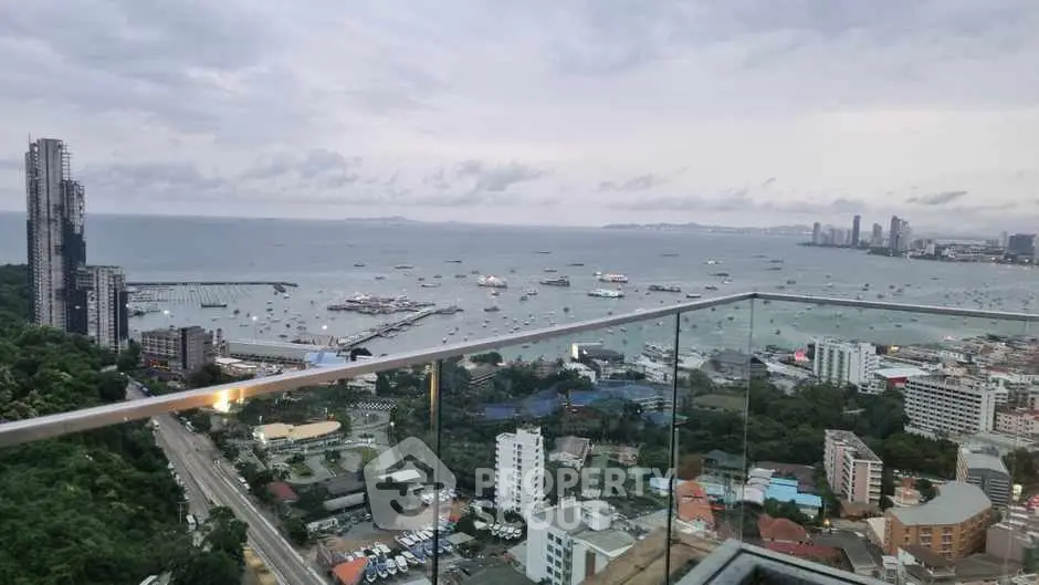 Stunning high-rise balcony view overlooking the ocean and city skyline