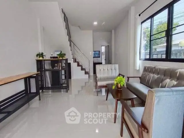 Spacious modern living room with sleek furniture and large windows