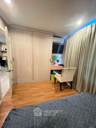 Cozy bedroom with wooden flooring and stylish furniture