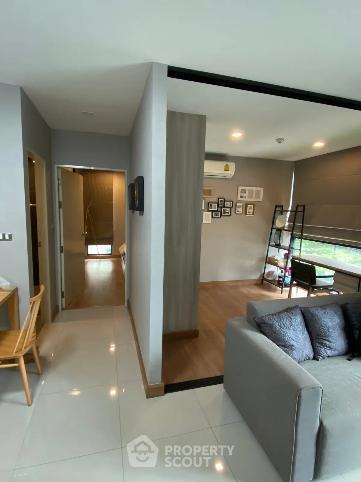 Modern living room with stylish decor and open layout, featuring a cozy sofa and wall art.