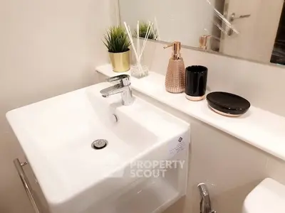 Modern bathroom with sleek sink and stylish decor accents
