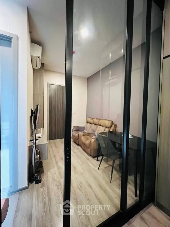 Modern living room with glass partition and cozy seating area