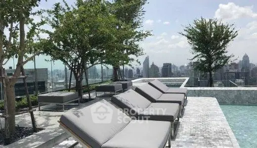 Luxurious rooftop pool with stunning city skyline views and modern lounge chairs.