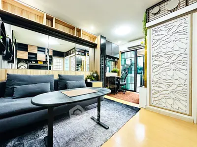 Modern living room with sleek design and stylish decor, featuring a cozy sofa and elegant partition.